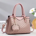 Pink fashion handbag with embossed lettering texture and adjustable shoulder strap detail - Pink