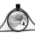 Macro view of blue moon and cat pendant on a black branch within glass cabochon - Black and White Quiet Moon Cat Silhouette (JY004165-2)