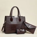 Detailed close-up of dark brown crocodile embossed leather 3-piece handbag set with gold hardware - Coffee