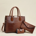 Detailed view of 3-piece dark brown lizard-texture tote set with golden hardware - Brown