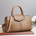 Détails de la texture crocodile et des coutures en Y sur le sac Boston marron - Kaki
