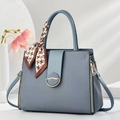 Greyish blue crossbody handbag with a twill texture and decorative scarf on handle - Blue