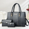 Close-up of three-piece black PU leather handbag set with tote, clutch and coin purse - Gray