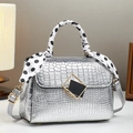 Silver crocodile pattern handbag with polka dot scarf and metal buckle on desk - 22cm x 10cm x 16cm / Silver