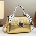 Detail of gold stone pattern handbag featuring silk scarf handle and metal buckle - 22cm x 10cm x 16cm / Gold