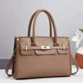 Detail of a brown leather and woven texture tote bag featuring a gold metal twist lock - Brown