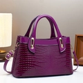 Detail of purple faux crocodile skin texture and gold hardware on stylish handbag - L30 W12 H18 / Purple