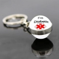 Macro view of Diabetic medical alert glass ball keychain on reflective surface - I'm Diabetic (JY005230-6)