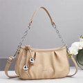 Detail of beige woven cloud bag with pleated texture and decorative silver sphere charms - Khaki