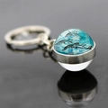 Zilveren dolfijn sleutelhanger met blauwe glazen bol hanger op reflecterend oppervlak - Dolfijn Kunst Patroon (JY005232-4)