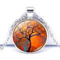 Detail of tree of life glass cabochon pendant with orange art motif and silver chain - Orange Red Swirl Tree (JY005355-3)