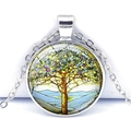 Close-up of Tree of Life glass cabochon pendant with silver metal chain on white background - Blue White Artistic Tree (JY005355-4)