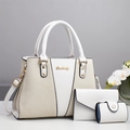 Detailed view of white faux leather and woven fabric set with gold metal logo and floral accents - Off White