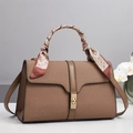 Close-up of woven brown leather handbag with silk scarf handle and golden metal buckle - Brown