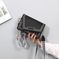 Elegant black envelope crossbody bag with contrast stitching and patterned web strap - Black