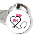 Macro detail of a silver keychain featuring a nurse RN logo and stethoscope design - Pink RN Nurse Hat (JY005477-6)