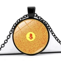 Macro shot of circular glass pendant with spiral mantra scripture and red Sanskrit character - Spiral Scripture Red Seed Word (JY005539-2)