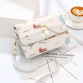 Elegant printed crossbody bag with golden cat lock on a white gift box setting - Cream White (With Two Straps)