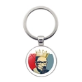 Macro view of a round metal keychain featuring a colorful pop art Ruth Bader Ginsburg portrait - Pop Art Memorial Portrait (JY006024-11)