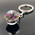 Close-up of hummingbird glass ball keychain with vibrant floral pattern and metal ring - Pink Purple Floral Cluster Hummingbird (XSWX2271-5)