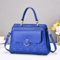 Close-up of quilted pattern and gold metal clasp on vibrant blue shoulder bag - Blue