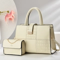 Detail of beige composite bag set showing stone pattern panel and gold metal chain strap - Off White