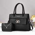 Chic black composite leather handbag set with gold hardware and logo on white surface - Black
