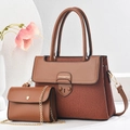 Close-up of brown textured leather handbag set with gold chain and brand logo details - Length 27 Width 12 Height 20 / Earthy Yellow