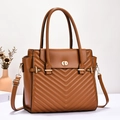 Detailed view of the chevron quilted texture and golden twist-lock on a brown tote bag - L30xW12xH26 / Earthy Yellow