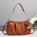 Detail of pleated brown handbag with fashion text and silver chain strap connector - 26cm x 7cm x 15cm / Earthy Yellow