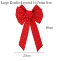 Dettaglio del fiocco rosso di Natale con stelle e lune dorate glitterate, 26x40cm - Stile D Stella Glitter