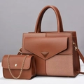 Macro detail of caramel brown patchwork tote bag set with metal buckle and chain strap - Earthy Yellow