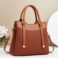 Detail of caramel brown multi-layer handbag with pleated leather texture and gold hardware - Earthy Yellow