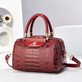 Elegant red crocodile embossed leather handbag with gold accents and shoulder strap - Burgundy