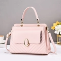 Elegant pink PU leather handbag with V-shaped stitching and gold buckle on a white table - Pink