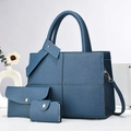 Detailed view of the 3-piece set featuring blue-grey lychee grain leather tote and pouches - Three-Piece Set / Blue
