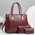 Detailed view of 3-piece burgundy tote set with leaf embroidery and gold hardware - L30 W12 H24 / Red
