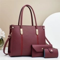 Detail of burgundy 3-piece bag set showing litchi grain texture and gold metal accents - Red