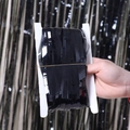 Detail of glossy black tinsel fringe curtain wrapped on a card for party backdrop decoration - 1*1m Black Matte Foil Fringe Curtain