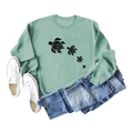 Close-up of light green sweatshirt featuring four black sea turtle prints and ribbed cuffs - Light Green (Black Font)