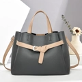 Detailed view of the dark grey pebbled leather tote with khaki handles and silver buckle - Gray