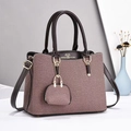 Detail of grey-pink canvas tote with brown leather handles and mini purse charm - Coffee