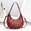 Detail of red crescent bag with glossy checkered texture and silver metal buckle charm - Wine Red