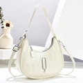 Chic off-white crescent moon shoulder bag with textured fabric and metallic charms - White