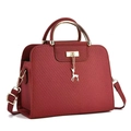 Deep red embossed crossbody bag with golden deer charm and curved metal handle - Wine Red