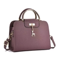 Detail of purple lychee textured leather handbag with gold deer charm and round handles - Purple