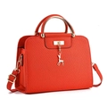 Detail of orange crosshatch leather tote with gold deer charm and metal handles - Red