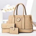 Detailed macro view of cream pebbled leather tote set with metallic logo and black edges - Three-Piece Set / Khaki