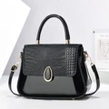 Glossy black crocodile pattern faux leather handbag with golden oval buckle and strap - Black
