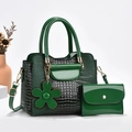 Detail of dark green crocodile texture handbag set with shiny patent leather finish - Green